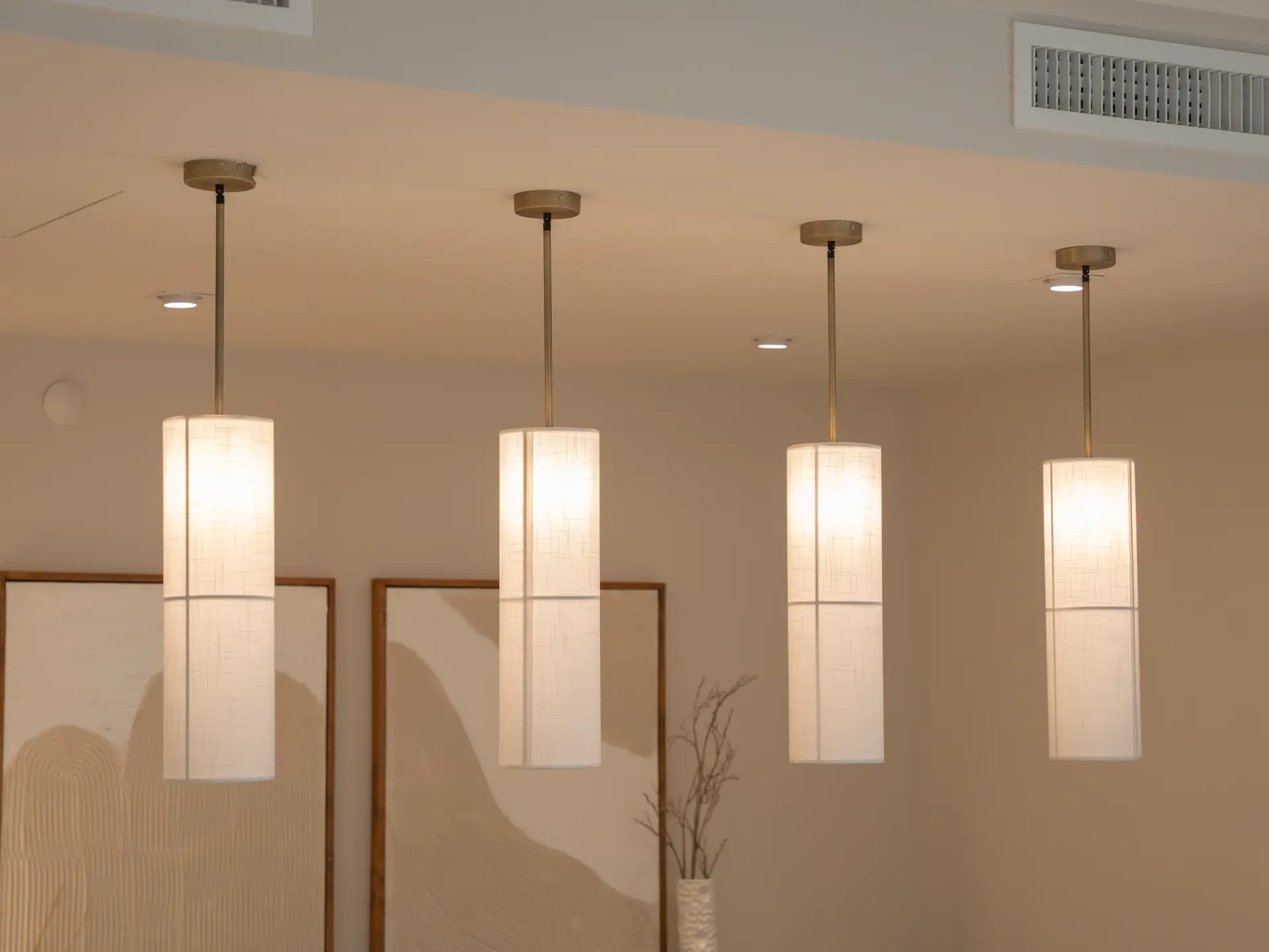 Sculptural pendant lights over modern dining table
