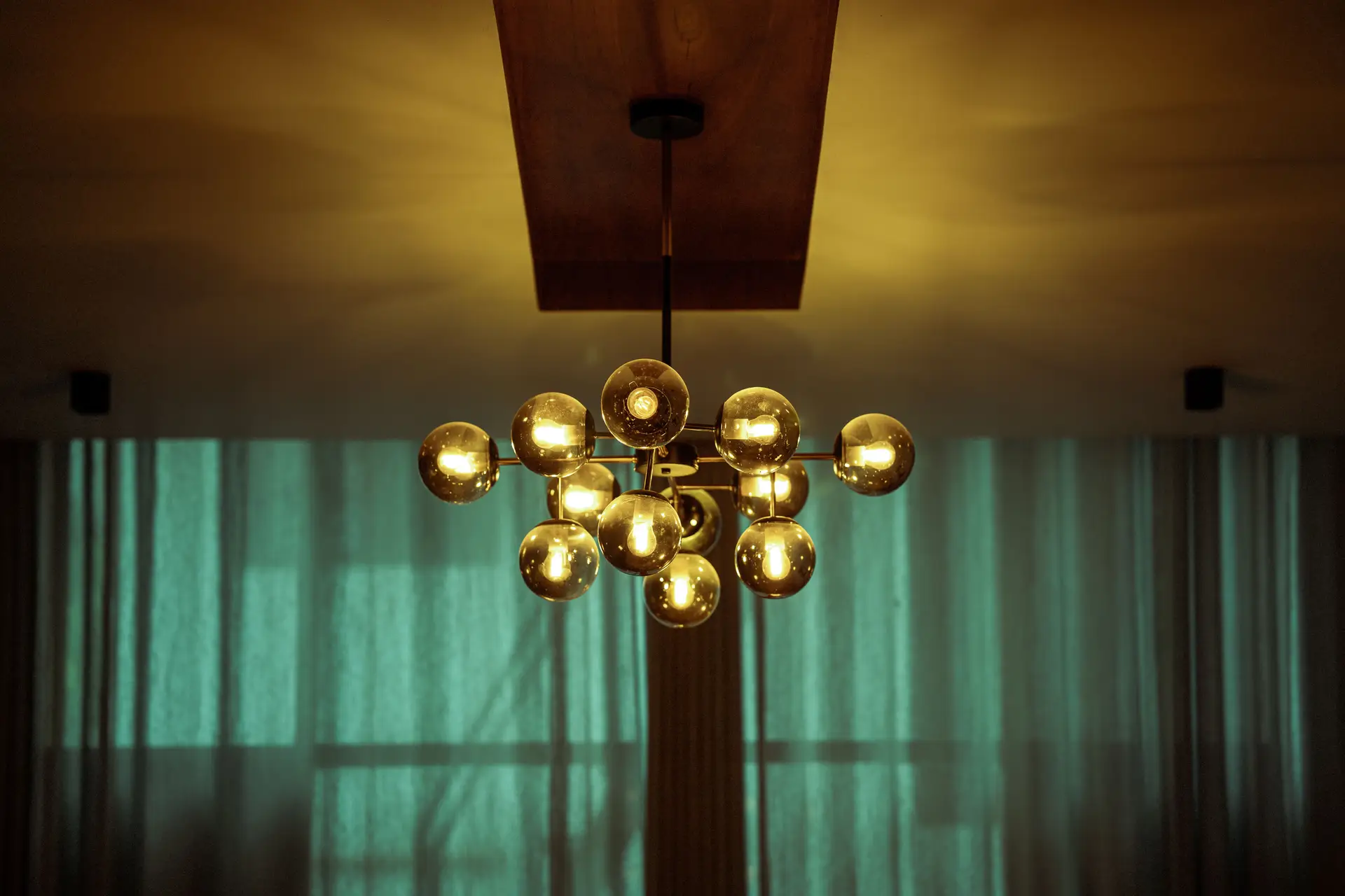 Sculptural brass luminaire illuminating a contemporary architectural interior