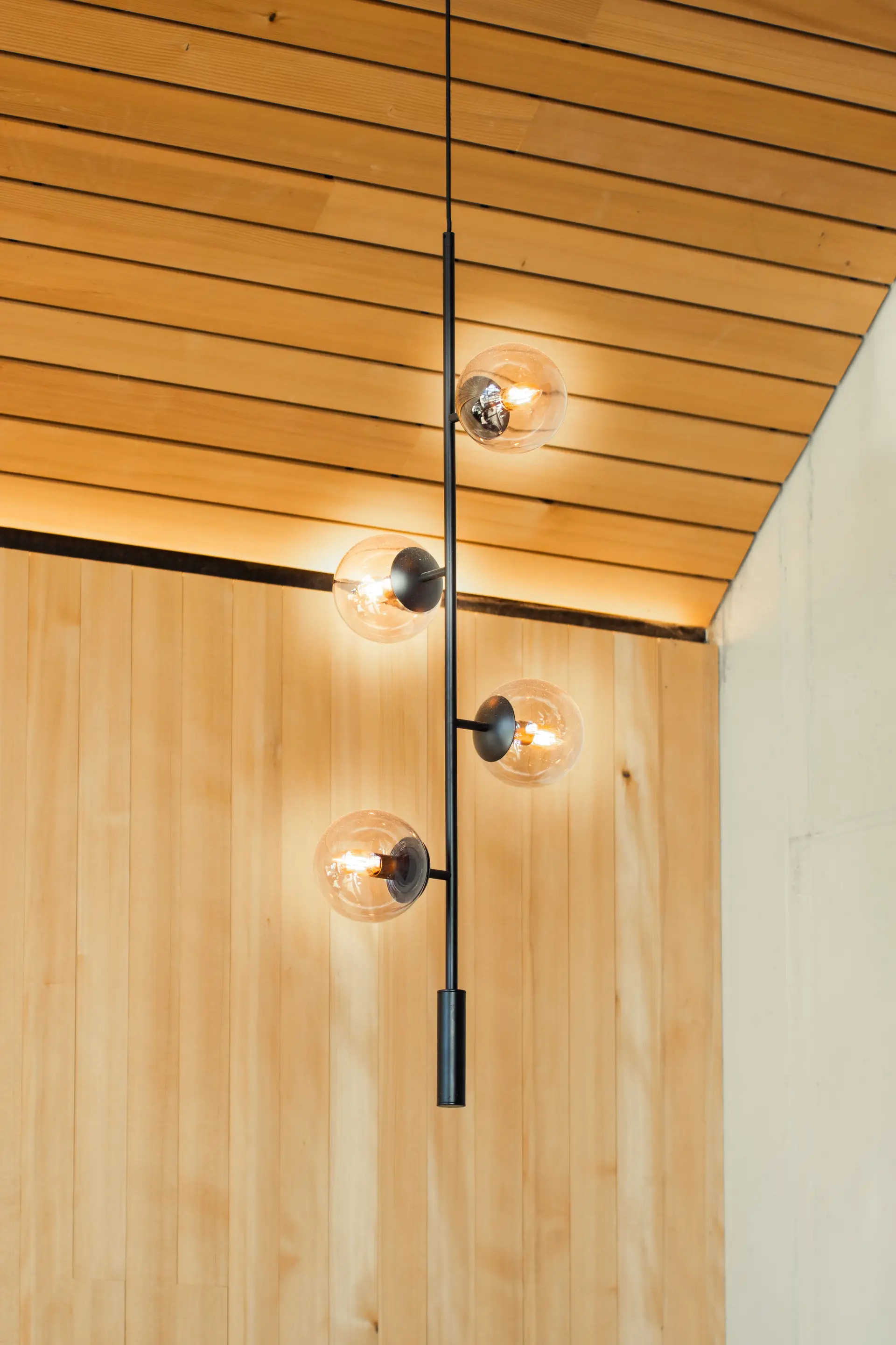 Pendant illumination highlighting natural cedar ceiling slats